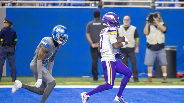 Minnesota Vikings Jordan Addison scores a touchdown against Detroit Lions Cameron Sutton.